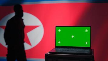 North Korea soldier using radar on green screen laptop to detect missiles during korean conflict. Pyongyang regime army soldier scanning rockets with chroma key notebook, close up shot, camera B photo