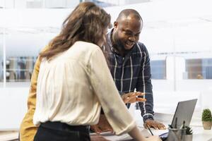 Corporate clients engage in office space planning session with a realtor, strategizing the layout and leasing terms for a high class urban workspace. Advises on investment opportunity relocation. photo