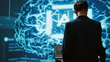 Startup employee looking over business charts, using AI software to take data driven decisions in tech industry. IT expert developing innovative artificial intelligence solutions for company, camera A photo