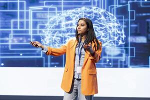 Computer scientist presenting how AI technologies can bring businesses increased productivity during IT expo. Specialist talks about implementation of AI driven solutions during tech workshop photo