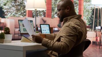 Business owner reviewing key performance indicators within the enterprise activity, remote work at home. Conducting evaluations to help with global expansion, finance and economy. Camera A. photo