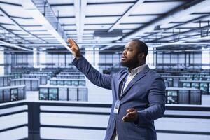 Engineer in data center implementing backup solutions to protect against data loss using AR hologram visualization. Server room worker resolving technical issues using augmented reality technology photo