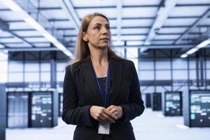 Computer scientist in data center identifying and solving technical issues related to data center infrastructure. IT professional managing, maintaining and securing high tech server hub workspace photo