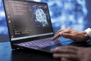 System administrator running AI cognitive computing tech on laptop to simulate computerized model. Close up of notebook used by IT specialist to do data mining with artificial intelligence photo
