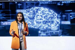 IT professional holding presentation exploring ways emerging AI technologies can enhance businesses workforce. Computer scientist at event presents strategies for using artificial intelligence photo