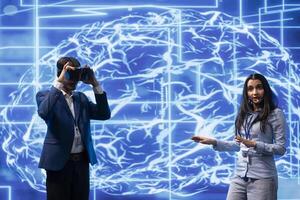 Tech specialists presenting VR headset and AI tech during summit presentation, exploring successful implementation of artificial intelligence and virtual reality in driving forward businesses photo