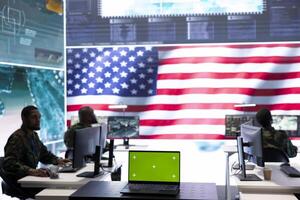 US army working in a top secret control center with isolated mockup screen, ensuring national safety while studying surveillance footage from radar cctv. Command service. photo