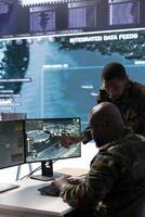 In a high tech military office, soldiers team analyze real time data collected by cctv surveillance system. Staff interpret intelligence and coordinate operations to ensure national defense mission. photo