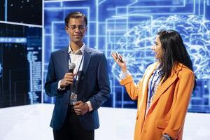 Tech specialists discussing during keynote event presentation, exploring successful implementation of AI in driving forward businesses, sharing latest artificial intelligence innovations photo