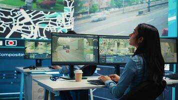 Indian shipping agency employee gathering data on traffic via surveillance footage, helping delivery trucks with cargo for shipment. Operator uses gps coordinates for tracking orders. Camera B. photo