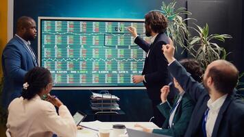 Sales management team reviewing global stock market trends in an informative meeting, extracting capital funds to start development projects. Business colleagues discuss enterprise growth. Camera B. photo