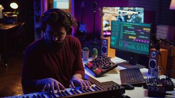 Musician producing new high quality piano tunes with daw software, recording a song with equalizer. Sound engineer creating melody to ensure high quality audio delivery, mixing console. Camera B. photo