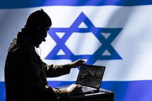 Mossad operative using detection gear analyzing surveillance data, standing isolated over Israeli flag background. Israel intelligence corps spy completing mission during geopolitical operation photo