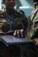 Army staff establishing new operating bases on a satellite world map visualization, ensure the national safety from the monitoring room at the base. Troopers operate CCTV radar footage. Close up. photo