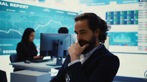 Project manager examining key performance metrics to ensure global business success, working with annual infographics to understand what needs improving. Multinational company activities. Camera B. photo