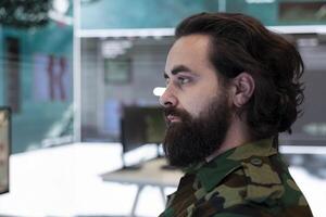 Major army officer studying surveillance satellite system on a world map to detect enemy through gps tracking in operation room. Anti terrorism secret service department. Close up. photo