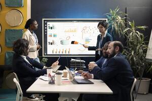Team members from a financial organization showing insight on new projects during an executive meeting. Team of colleagues discussing the agenda for upcoming events in the industry. photo