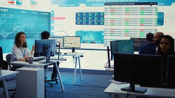 Forecast affiliates working in coworking space office to review latest business news based on performance metrics and progress. Consultants fight to expand the enterprise globally. Camera B. photo