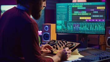 Audio engineer creating sound effects for a new soundtrack, recording tunes on electronic piano and adding creativity to audio project. Songwriter producer editing and mixing recordings. Camera A. photo