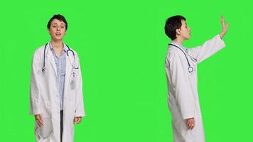 General practitioner welcoming patients and inviting them to come closer, greeting sick persons at checkup exam appointments. Doctor waving at people and asking them to approach her. Camera B. photo
