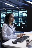 Data center call center agent responsible for providing logistics support to businesses. Worker in server farm establishment overseeing infrastructure systems and communicating with engineers photo