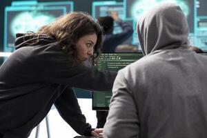 Governmental hackers working together on digital security and cyber defense measures. Engaging in cyber operations, network security and data protection during information war. photo