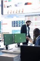 Business analyst examining monthly results and performance metrics online, isolated screen in multinational company headquarters. Consultant reviews income and expenditure budget. photo