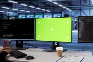 Green screen computers in data center facility managing rackmounts energy consumption. Mockup PC monitors used for automation and monitoring processes in server room, close up photo