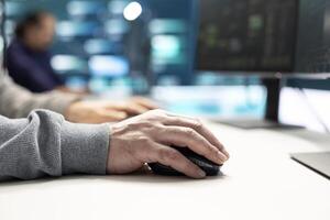 Cyber security experts in a governmental hacking room working on securing networks. Hackers focusing on malware detection, cyber operations and protection against digital mercenaries. photo