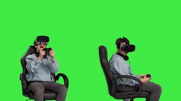Player using virtual reality glasses to have fun on cyberspace gaming competition, playing games and winning. Gamer against greenscreen backdrop uses vr headset and controller. Camera B. photo