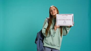 Portrait of smiling student holding high school diploma, celebrating passing classes with high marks, attending graduation ceremony. Happy young girl delighted about receiving certification, camera B photo