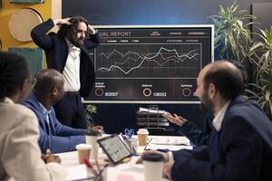 Frustrated overworked supervisor explaining resource allocation to his staff, enterprise workers preparing a pitch for the shareholders meeting. Teammates working to obtain more capital. photo