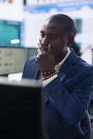 Company investor studying annual reports on a computer, gathering infographics to approve resources allocation for an expansion project. Analyst examines enterprise productivity. photo