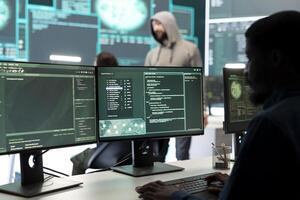 Governmental hackers team securing computer systems from cyber threats, working together in agency control room. Emphasizing encryption, online security and espionage against cyber attacks. photo