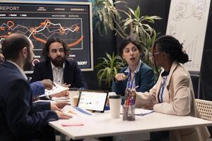 Colleagues evaluating infographics data analysis in an executive meeting, corporate restructuring or organizational changes. Adapting the organization to evolving market conditions for growth. photo
