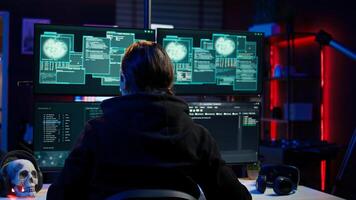 Cheerful cybercriminal celebrating after managing to get past security systems, hiding in secret HQ. Joyous hacker feeling proud after breaching defenses using rogue scripts, camera B photo