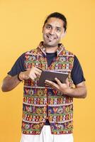 Portrait of happy man smiling while adding payment method on tablet, delighted to take advantage of promotions. Ecstatic person excited to do internet shopping on digital device, studio background photo