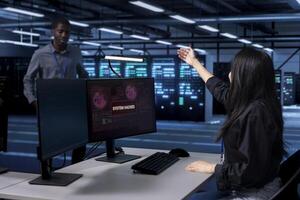 Admin in server room frightened by hacking attack on computers targeting data, requesting assistance from coworker. Employee calling colleague to help her save data center from unauthorized access photo