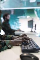 Army officer reviews operation details in a control center military headquarters, manages personnel and resources for missions. Task force command works with satellite radar station. Close up. photo