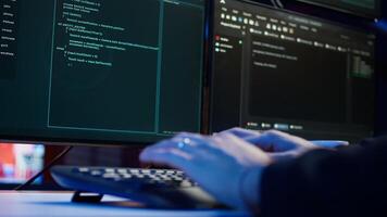 Cybercriminal illegally breaching security systems while hiding in secret HQ, close up shot. Scammer breaking down security systems firewalls using rogue scripts to steal sensitive data, camera B photo