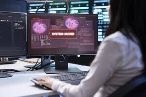 System administrator in server room frightened by sensitive data threatened by hacking attack on computers. Woman afraid of cyberattack, struggling to save data center from unauthorized access photo