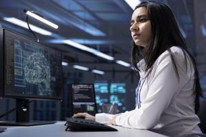 Admin working on PC in data center with artificial intelligence technology to process massive datasets. Worker solving tasks in server hub storing data used for deep learning photo