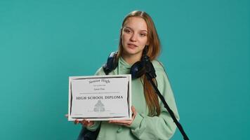 Overjoyed student celebrating achievement, holding diploma, using microphone to do speech, studio background. Woman using mic to share wisdom with colleagues after finishing school, camera A photo