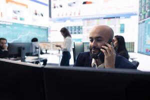 Staff member on phone call pitching an expansion idea directly to the investor, presenting key performance indicators and annual success reports in order to obtain more funds. photo