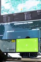 Intelligence analyst reviews air and sea activity next to an isolated mockup display, following gps coordinates of vessels anchoring in the ports. Army trooper working in monitoring room. photo