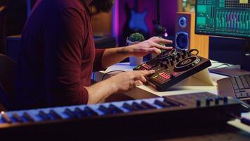 Audio engineer recording piano keyboard instrument notes and vocals, operating a mixing console with amplifier and daw software on computer. Artist editing sounds for music industry. Camera A. photo