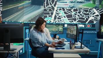 Employee navigating on satellite radar and map to search for routes, helping courier to avoid traffic and successfully deliver orders. Operator in monitoring room using gps coordinates. Camera B. photo
