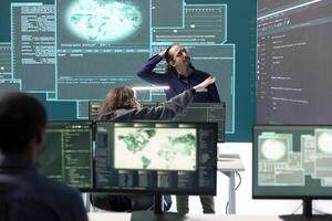 Cyber operations center with governmental hackers working on digital security activities during hybrid war. Specialists team ensuring security and malware detection, cyber surveillance. photo