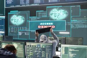 Displeased irritated team of hackers with denied access message on a big screen in governmental operations agency. Experts struggling to break into databases and steal server information. photo
