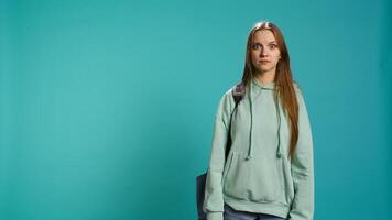 Young actress goofing around, switching emotions, trying different facial expressions, practicing for theatre class, studio background. Teenage woman making silly faces, camera B photo